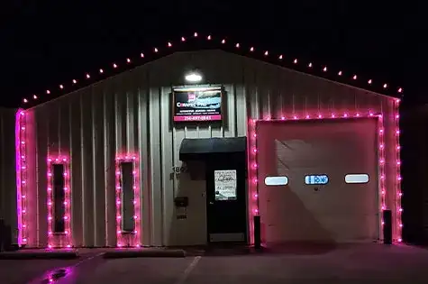 Commercial shop building outlined in pink lights